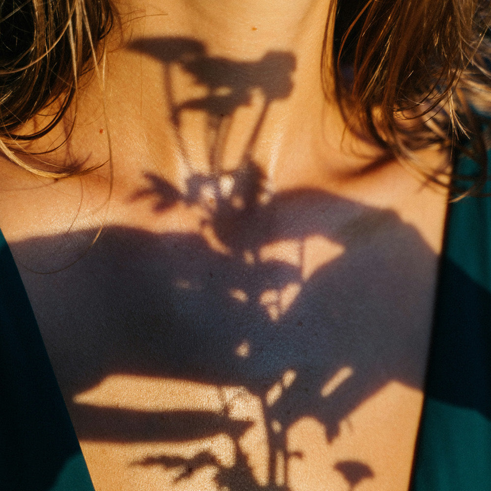 Shadows across womans chest